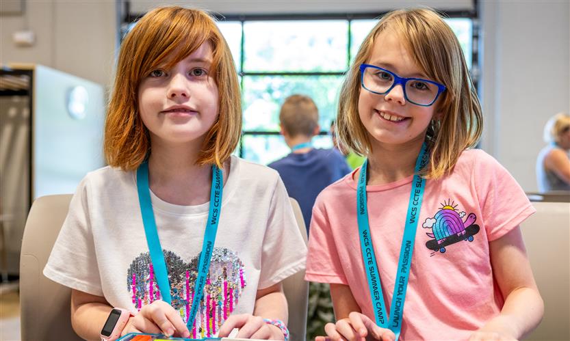 Two girls smile at a STEM Camp